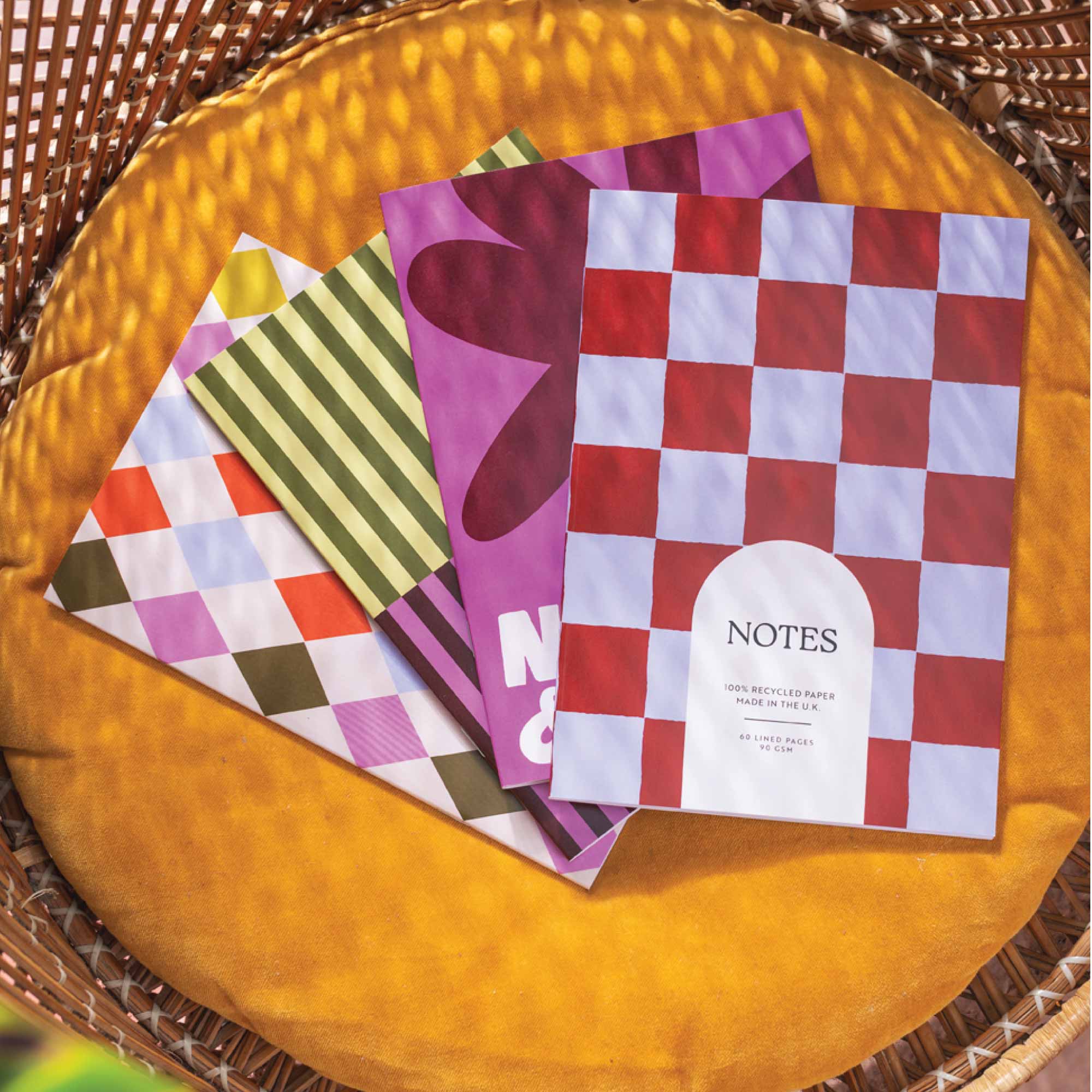 Colorful patterned notebooks on a textured surface