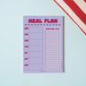 Lilac & Plum Meal Planner and Shopping List Notepad. On a light blue background. Monthly tracker.