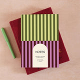 Lined 60 page notebook with pistachio green and plum purple stripe design.