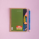 Birthday card with a colorful mushroom design on the cover and a blue pen on a pink background