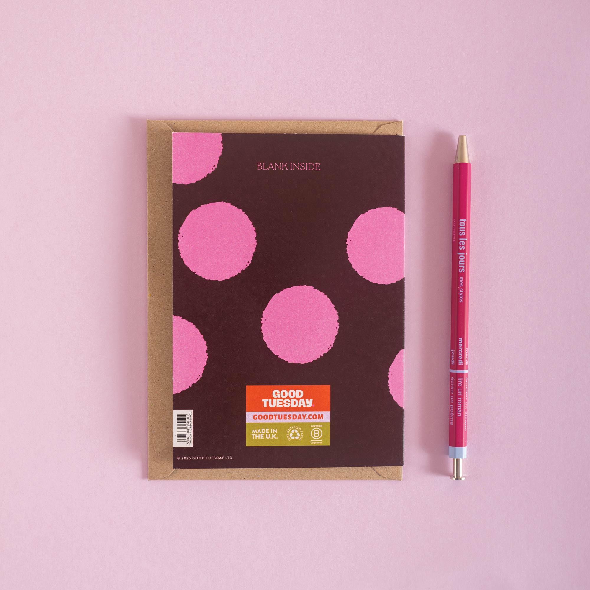 Christmas Card with pink polka dots and a pen on a pink background