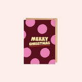 Greeting card with pink polka dots and 'Merry Christmas' text 