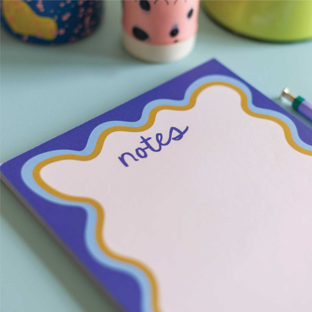 a5 notepad with blue wavy border. recycled paper notepad. compact notepads.