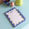 a5 notepad with blue wavy border. recycled paper notepad. compact notepads.