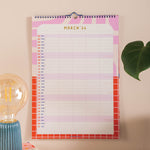 Inside of the 2025-2026 academic year family planner - showing the 5 column planner hung up on the wall.