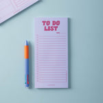 Lilac and Plum Notepad with 'To Do List' text and a pen on a light blue background