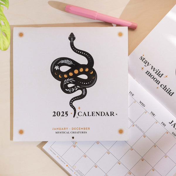 2025 compact fantasy wall calendar featuring mystical creatures, star constellations, and crystal elements in a line art style with uplifting quotes, printed on recycled paper