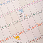 close up showing 2026 wall planner in use, with writing and stickers