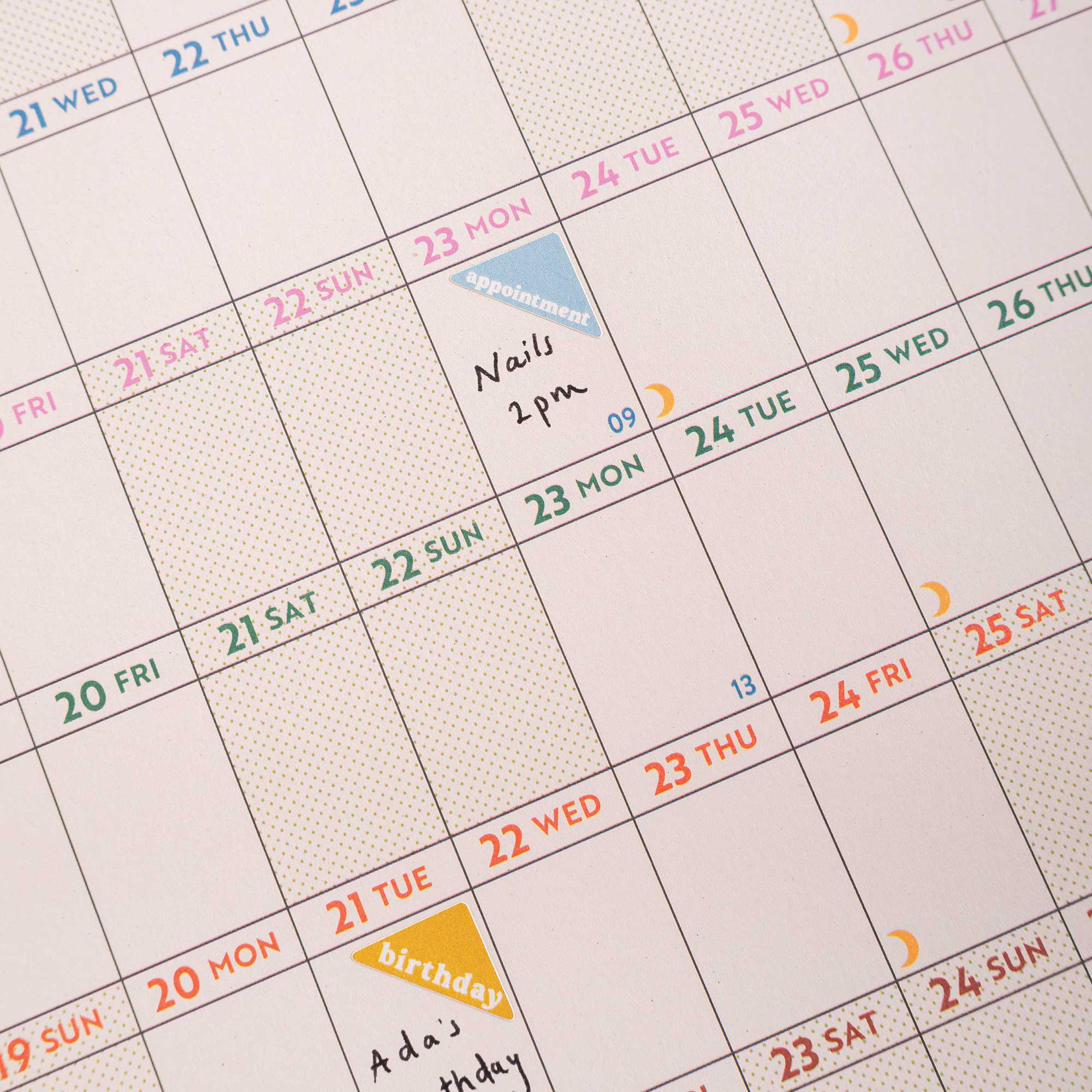 close up showing 2026 wall planner in use, with writing and stickers