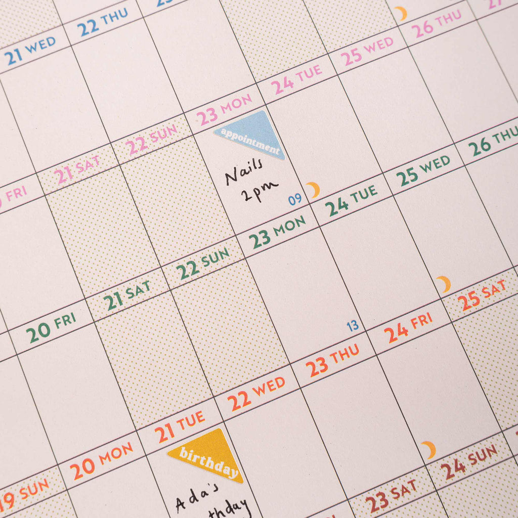 close up of academic wall planner in use with writing and stickers