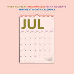 Detail shot of colourful calendar grid layout and type. Showcasing the week numbers, moonphases, holidays and mini month overview