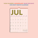 Detail shot of colourful calendar grid layout and type. Showcasing the week numbers, moonphases, holidays and mini month overview