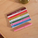Work Hard Play Nice habit tracker pad styled on a desk with pen