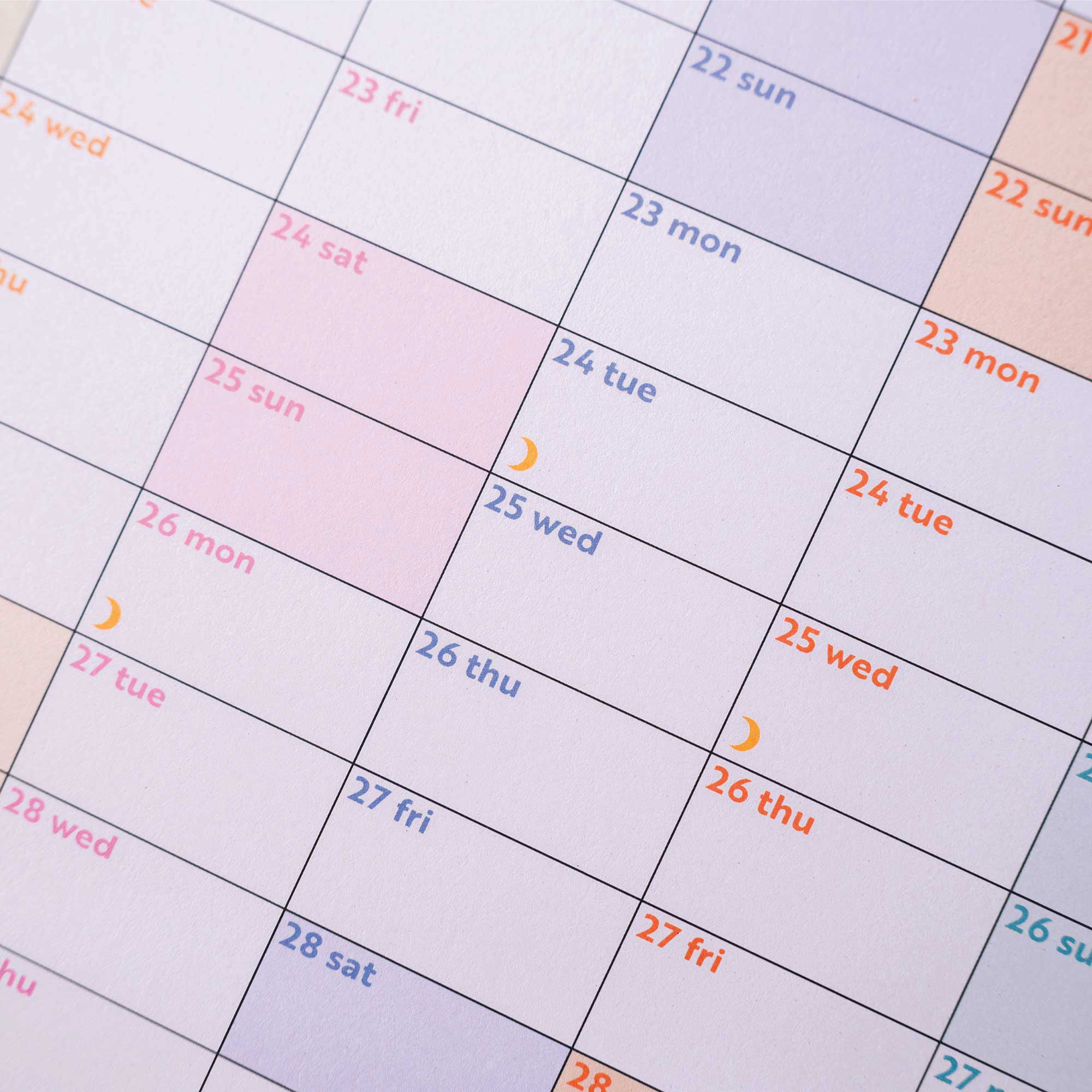 Year-at-a-glance planner with weekends and moon phases subtly highlighted