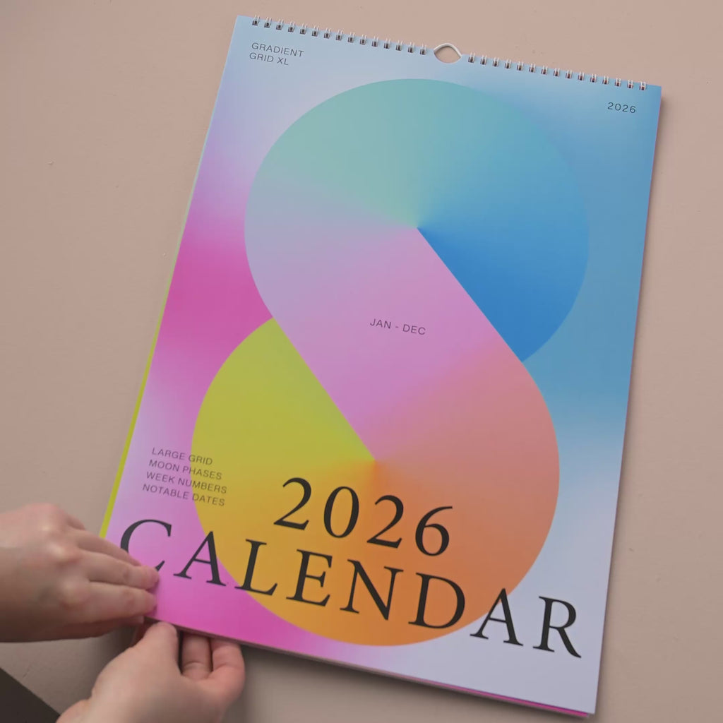 Good Tuesday's 2026 calendar with colorful gradient design. 100% recycled paper.